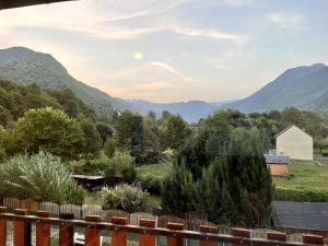 a view from the deck of a house in the mountains at Mountain view 3-bedroom Pyrenees apartment in Saint-Béat