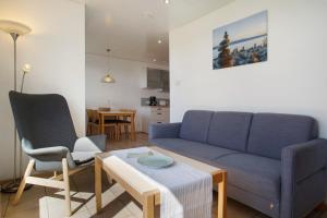 a living room with a couch and two chairs and a table at Gästehaus Heinemann - Og1 in Langenargen