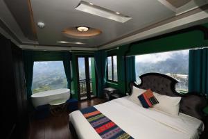 a bedroom with a bed with a large window at Sapa Nature View Hotel in Sa Pa