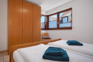 a bedroom with two beds with towels on them at Gästehaus Heinemann - Og1 in Langenargen
