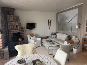a living room with a couch and chairs and a table at The Vrådal Pearl in Vradal
