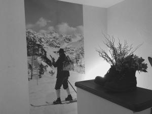 a person standing on skis in a room with a painting at Ferienhaus Alpenperle in Grainau