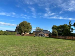 a large yard with a house and a playground at Charming Countryside Retreat in Saint-Georges in Clavé