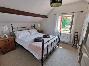 a bedroom with a bed and a window at Charming Countryside Retreat in Saint-Georges in Clavé +9 photos