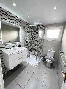 a bathroom with a shower and a sink and a toilet at B17 Caleton blanco in Tías