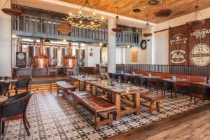 a restaurant with tables and chairs in a room at Strand Hotel Swakopmund in Swakopmund