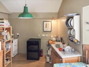 a kitchen with a sink and a stove top oven at Campbells Stables in Berwick-Upon-Tweed +3 photos