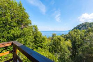 a view of the water from a wooden deck at Casette nel Parco in Portoferraio