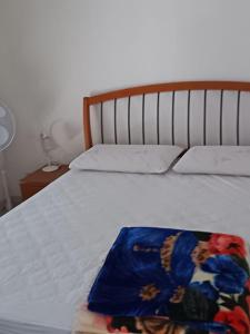a bed with a blanket on top of it at Giada Apartment in Menton +1 photo