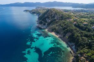 an aerial view of a beach with turquoise water at Casette nel Parco in Portoferraio