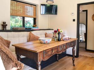 a wooden table in a living room with a couch at Clematis - Uk50451 in Ruswarp
