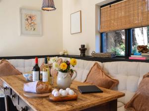 a table with bread and wine and flowers on it at Clematis - Uk50451 in Ruswarp