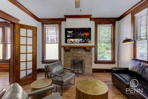 a living room with a couch and a fireplace at Spacious 3-in-1 Vintage Brick Escape in Memphis