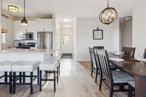 a kitchen and dining room with a table and chairs at Alpine Breeze Getaway at Blue in Blue Mountains