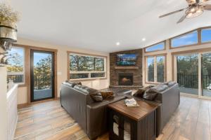 a living room with a couch and a fireplace at New The Pine Getaway Lots of Room Hot Tub Views in Conifer