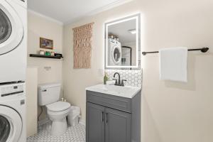a bathroom with a sink and a washing machine at Hygge High Point by Rather Be Properties in High Point