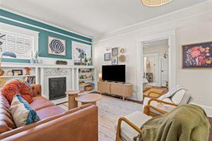 a living room with a couch and a fireplace at Hygge High Point by Rather Be Properties in High Point