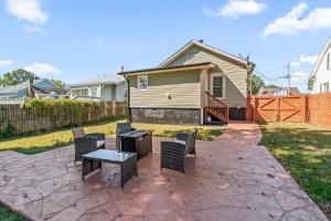a patio with chairs and a table and a house at Hygge High Point by Rather Be Properties in High Point