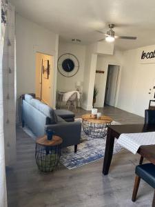 a living room with a blue couch and two tables at 216 The Governors Suite at The George in Klamath Falls