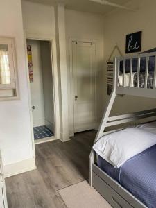 a bedroom with a bed and a walk in shower at 216 The Governors Suite at The George in Klamath Falls