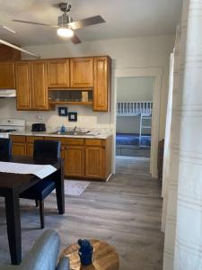 a kitchen with wooden cabinets and a dining table at 216 The Governors Suite at The George in Klamath Falls +1 photo