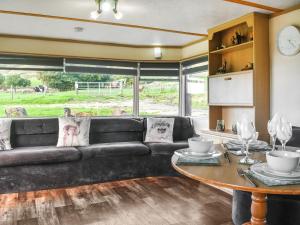 a living room with a couch and a table at Croft - Uk50042 in Clitheroe