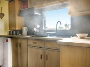 a kitchen with a sink and a window at Croft - Uk50042 in Clitheroe