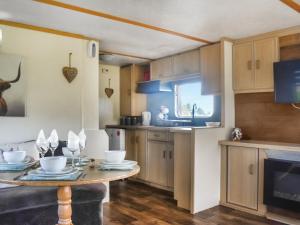 a kitchen with a table and a sink and a stove at Croft - Uk50042 in Clitheroe