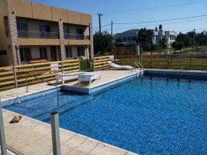 a large swimming pool in front of a building at Complejo Marlu in Federación