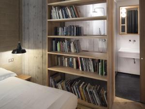 a bedroom with a book shelf filled with books at Concoct Milano in Milan