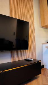 a large flat screen tv hanging on a wall at EASY RENT- Szeligowskiego 15 Chodźki Residence, Free Parking, 24h Check-in in Lublin +13 photos