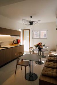a living room with a table and chairs and a kitchen at Atelier Inn Vaticano in Rome