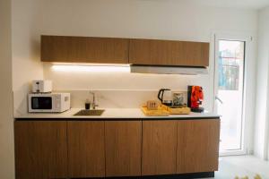 a kitchen with a sink and a microwave at Atelier Inn Vaticano in Rome