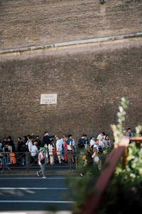 a crowd of people standing in front of a wall at Atelier Inn Vaticano in Rome +34 photos