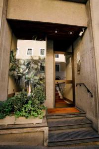 a front door of a building with a plant at Atelier Inn Vaticano in Rome