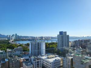 a view of a city with a river and buildings at SunU Seoul Stay - All Rooms 45m Panoramic Han River View - 4m Ceiling in Seoul