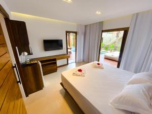 a bedroom with a bed with two towels on it at Hura Vilas in Itarema +17 photos