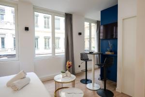 a room with a bed and a table and some windows at Le Chenavard II-Coeur Lyon-Central Air Conditioning in La Celle-sous-Gouzon +7 photos