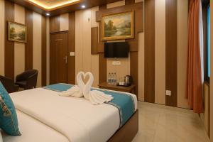 a bedroom with a bed with a heart decoration on it at Ramayana Grand Hotel Ayodhya - Just Steps Away from Ram Mandir in Ayodhya