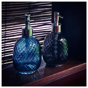 two blue vases sitting on a wooden shelf at Sans Murs Dans la Nature in San-Martino-di-Lota