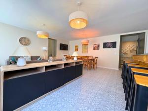 a kitchen and dining room with a dining table at l'Ancien Bistrot in Saint-Martin-de-Bréthencourt