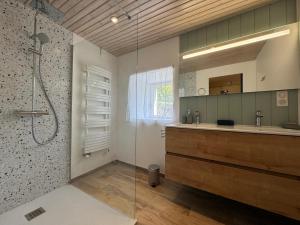 a bathroom with a glass shower and a sink at l'Ancien Bistrot in Saint-Martin-de-Bréthencourt +28 photos