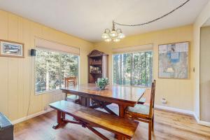 a dining room with a wooden table and two benches at Take me back to Talbot in South Lake Tahoe