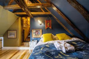 a bedroom with a large bed in a attic at The Famous Harry Potter House in Saffron Walden