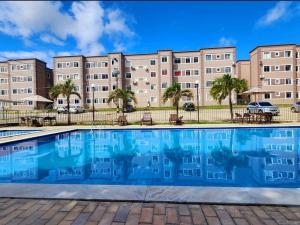 a swimming pool in front of a building at APT Superior CABO BRANCO - Ar condicionado nos 2 quartos - WiFi - Próx a praia de Cabo Branco, a UFPB e ao centro de convenções in João Pessoa