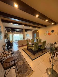 a large living room with a table and chairs at Metia residence in Shah Alam