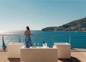 a woman standing on a cruise ship looking out at the water at Dukley Hotel & Resort in Budva