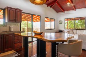 a kitchen with a wooden table in a room at Casa Quetzal in San Luis