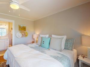 a bedroom with a large white bed with pillows at La De Da House in Tybee Island +12 photos