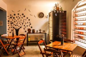 a dining room with two tables and a fireplace at Red Monkey Hostel Barra Funda in São Paulo